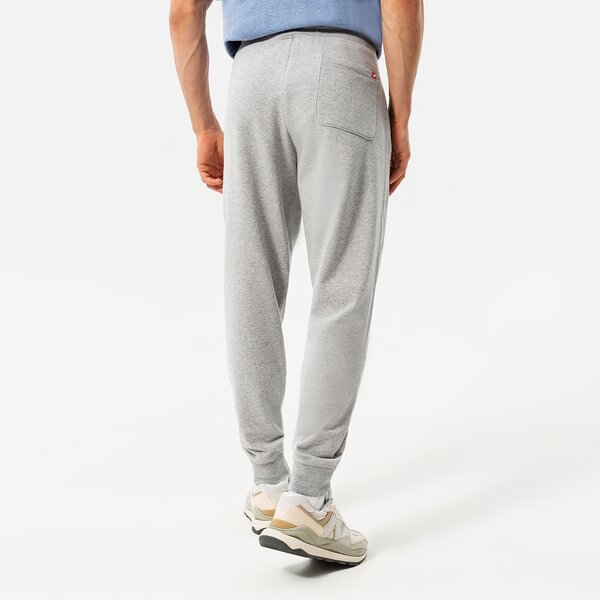 Vīriešu bikses NEW BALANCE BIKSES NB ESSENTIALS STACKED LOGO SWEATPANT mp03558ag krāsa pelēka